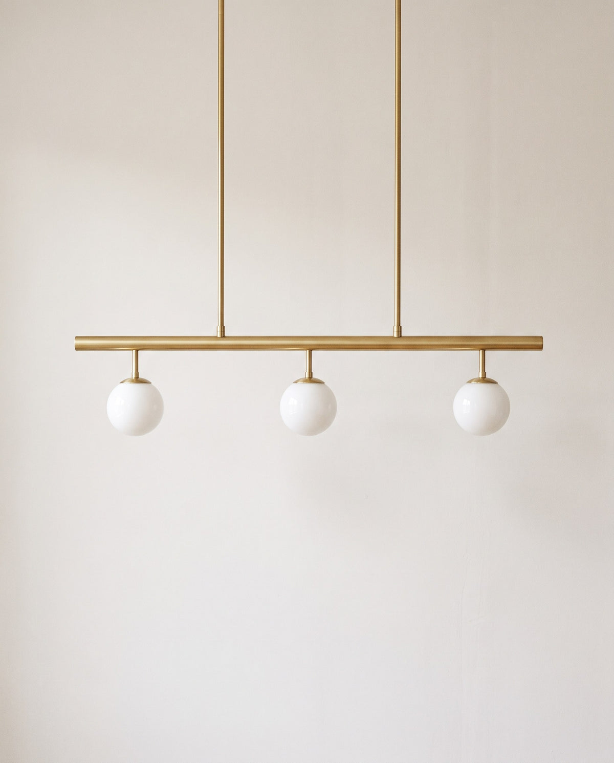 Nothoro Trio Linear Pendant Light – 36" Brushed Brass Bar with 3 Opal Glass Globes, Kitchen Island Chandelier